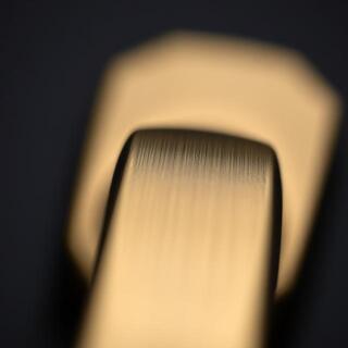 Brushed brass lever — grain close-up